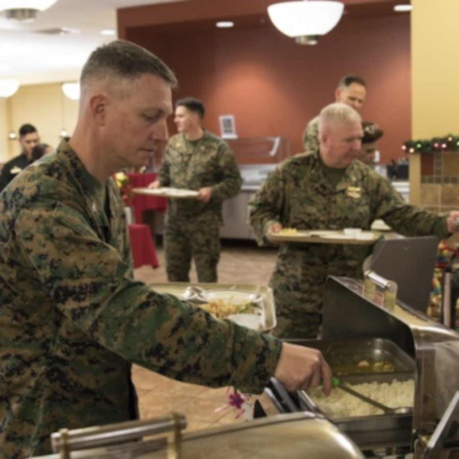 U.S. Marine Corps Col. Mikel Huber, the commanding officer of Marine Corps Air Station (MCAS) Cherry Point, gets food during a Chef of the Quarter competition at MCAS Cherry Point, North Carolina, Dec. 13, 2019. Each contestant presented a meal to a panel of four judges and were scored based on a variety of things, including presentation and taste. (U.S. Marine Corps photo by Lance Cpl. Jacob Bertram)