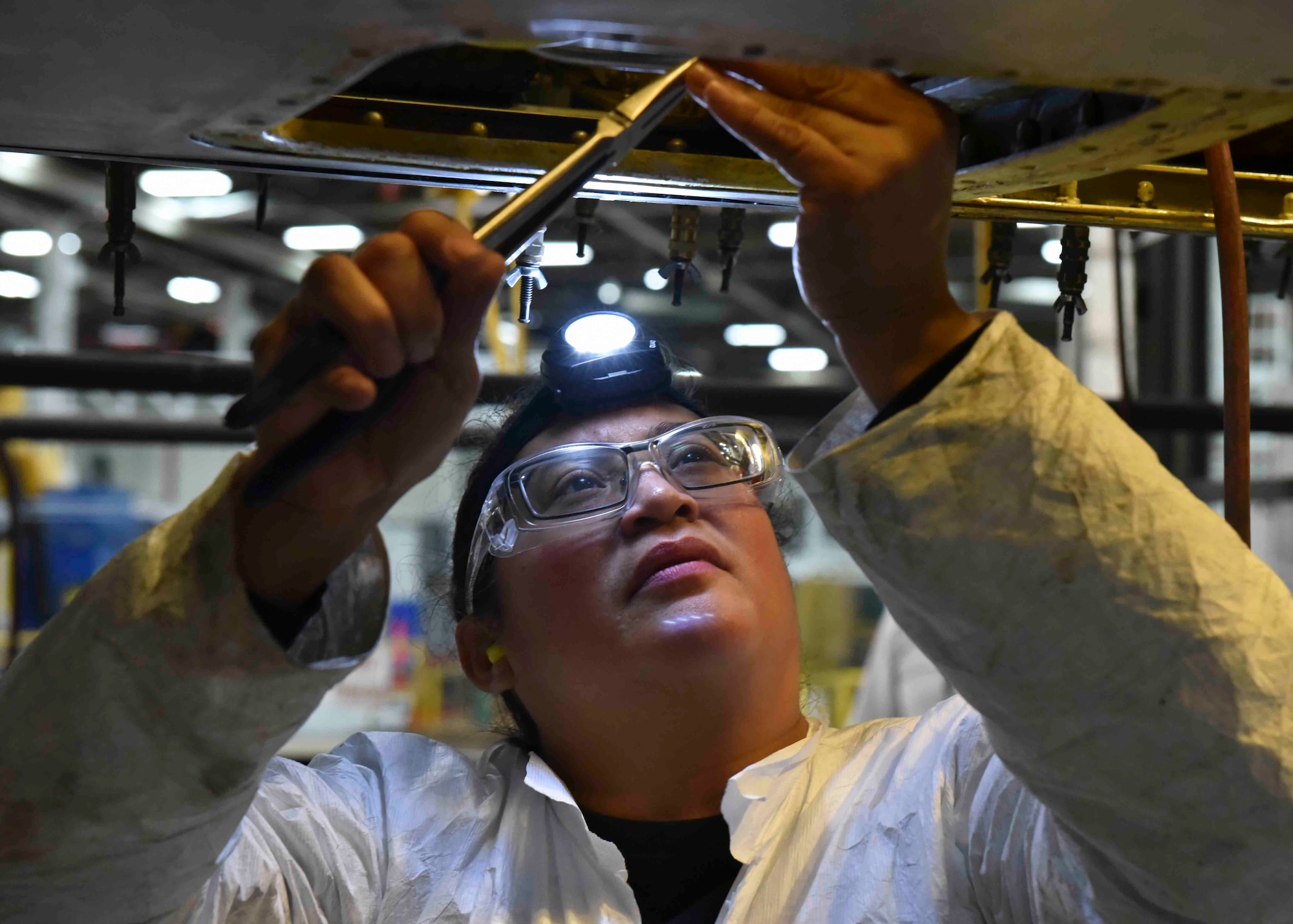 A 564th Aircraft Maintenance Squadron worker performs a programmed depot maintenance inspection of a KC-135 Stratotanker at the Oklahoma City Air Logistics Complex on Tinker Air Force Base, Oklahoma Nov. 23, 2019. Inspections determine what defects need to be addressed and what parts require fixing and updating. (U.S. Air Force photo by Airman Kiaundra Miller)