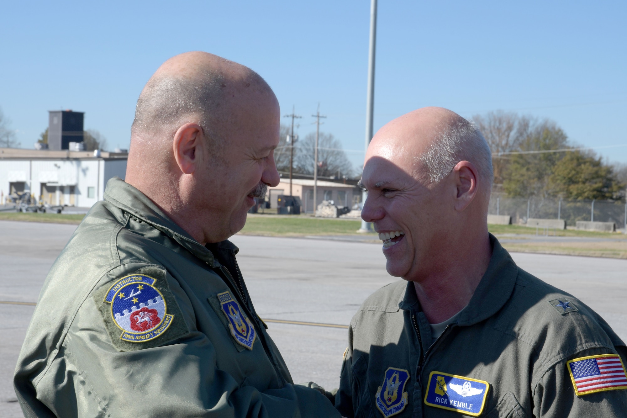 Chief Master Sgt. Terry Studstill, 700th Airlift Squadron flight engineer superintendent, left, greets Brig. Gen. Richard Kemble, shortly after the general landed at Dobbins Air Reserve Base, Ga. on Dec. 20, 2019. The flight marked 6,000 flying hours for Kemble. (U.S. Air Force photo/Tech. Sgt. Andrew Park)