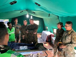 United States and Indian military medics work together during a medical subject matter expert exchange at Kakinada Beach, India, Nov. 20, 2019. The SMEE focused on lessons learned and table top exercises on performing humanitarian disaster and relief operations in a post-disaster environment, where roads, air and seaports are no longer accessible due to a natural disaster. (Courtesy photo)