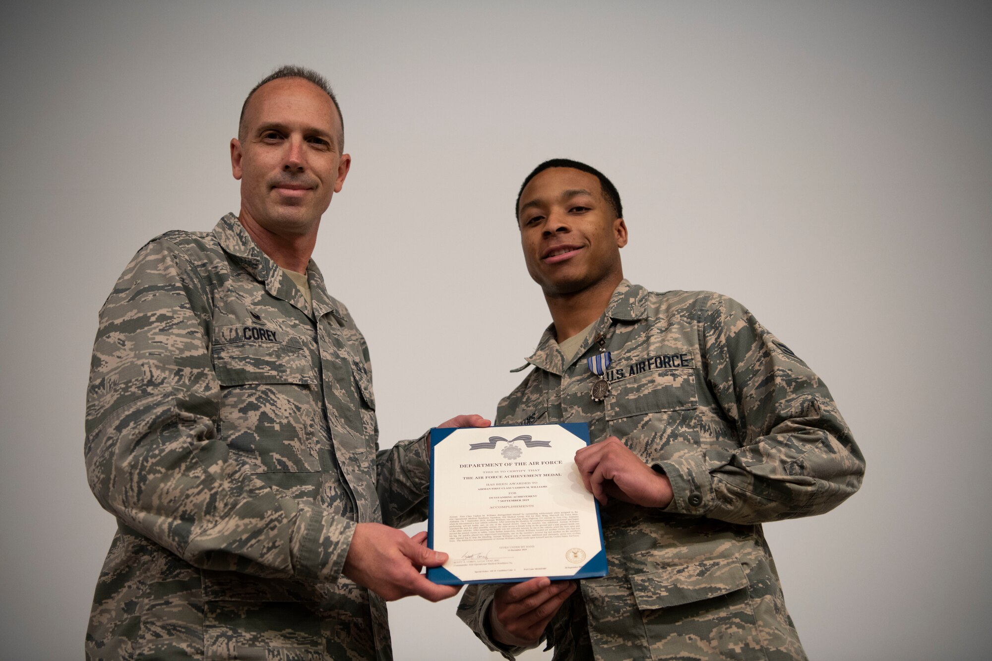 Lt. Col. Scott Corey, 42nd Operational Medical Readiness Squadron commander, presents  Airman 1st Class Vashon Williams, 42nd OMRS dental assistant, with the Air Force Achievement Medal during a ceremony December. 19, 2019, at Maxwell Air Force Base, Alabama. Williams witnessed the aftermath of a four-car pileup and performed life-saving first aid to several victims.