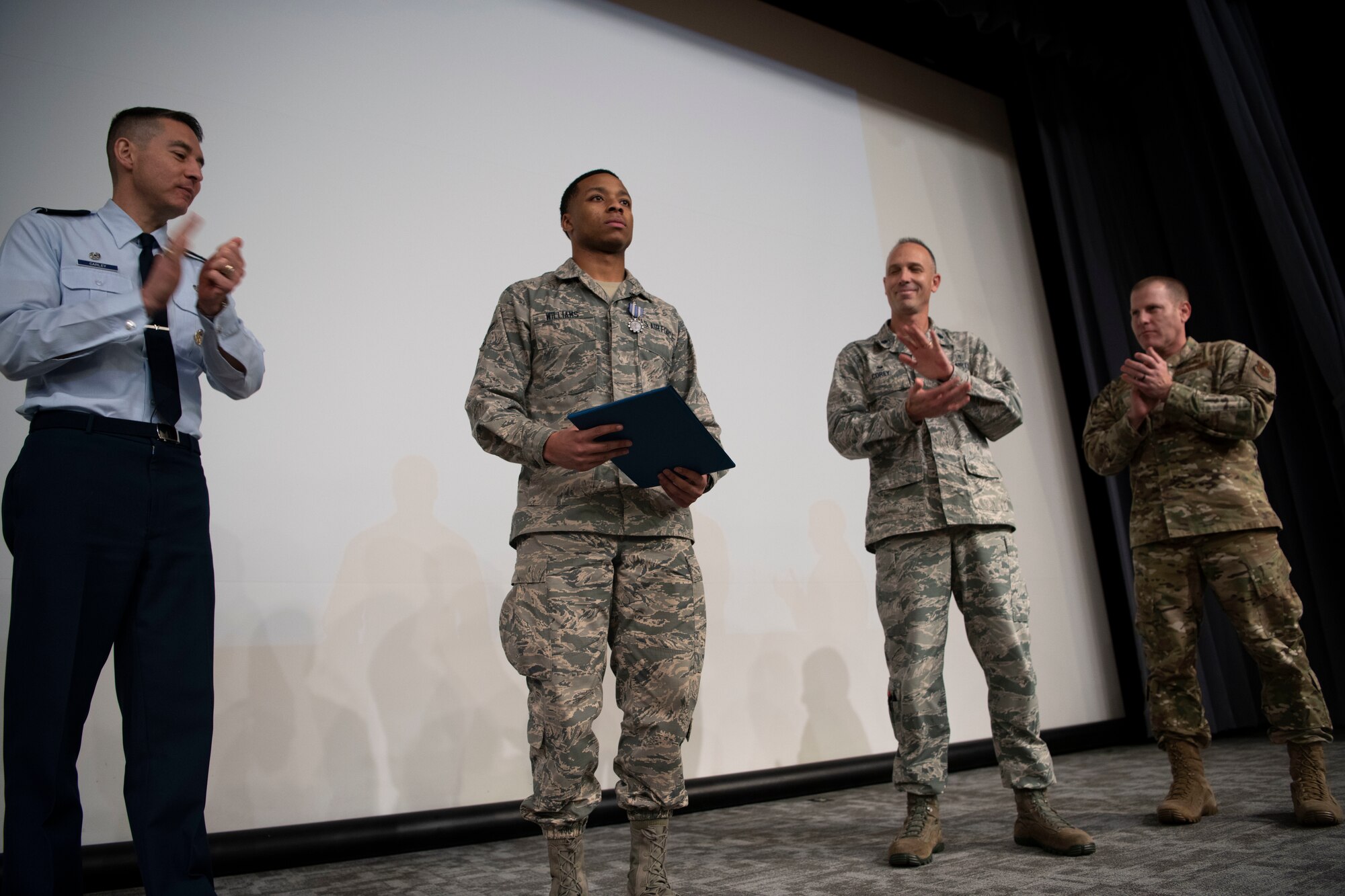 Airman 1st Class Vashon Williams, 42nd Operational Medical Readiness Squadron dental assistant, receives applause during a ceremony in which he is presented with the Air Force Achievement Medal December. 19, 2019, at Maxwell Air Force Base, Alabama. Williams applied life-saving first aid to victims of a four-car pileup.