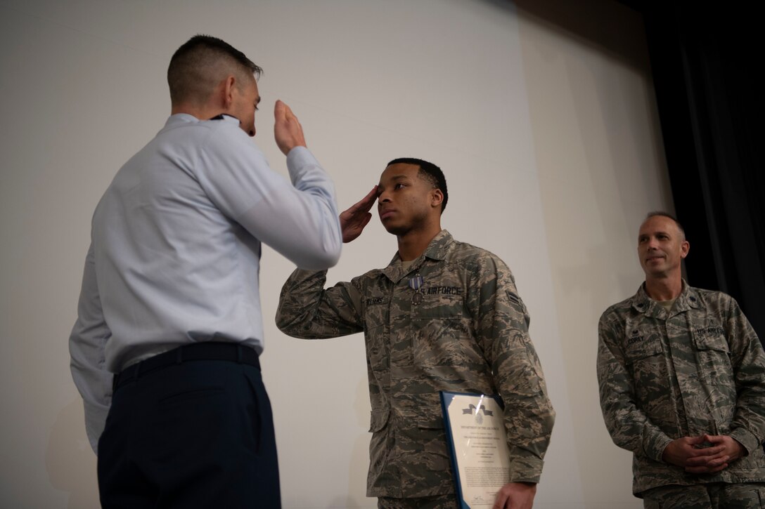 Col. Patrick J. Carley, 42nd Air Base Wing commander, exchanges a salute with Airman 1st Class Vashon Williams, 42nd Operational Medical Readiness Squadron dental assistant, during a ceremony December. 19, 2019, at Maxwell Air Force Base, Alabama. Following a four-car pileup, Williams stopped to apply a tourniquet to the leg of a victim, effectively saving their life.