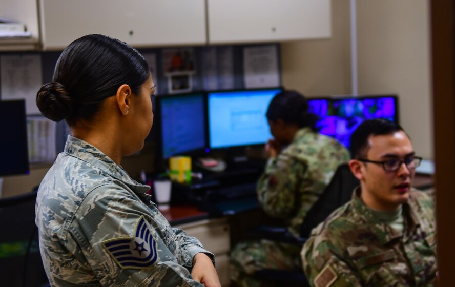 an airman receives a briefing from another airman