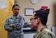 an airman receives a briefing from another airman
