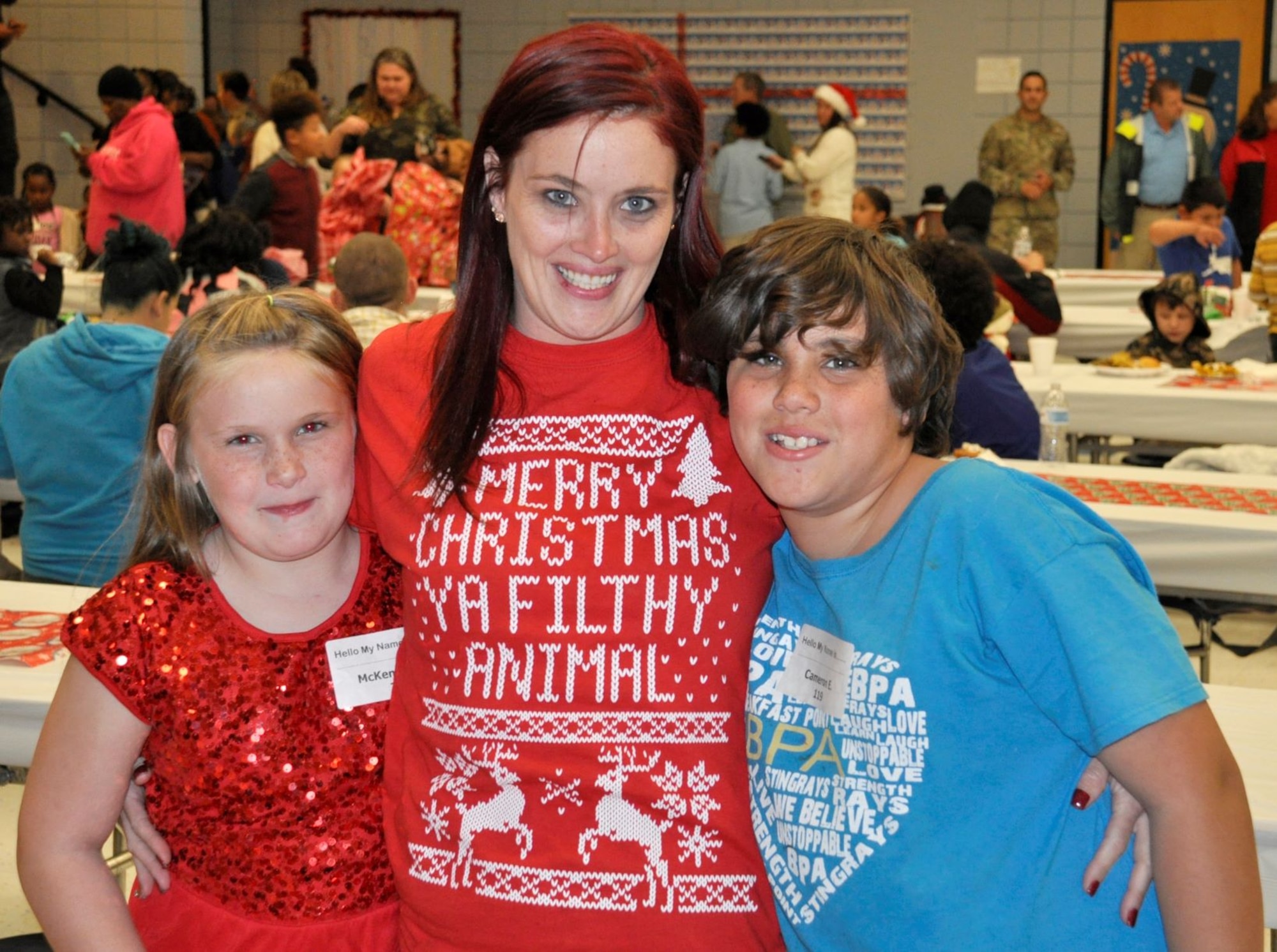 Tiffany Eldridge and her two children were all smiles Dec. 19 at the annual “Spread the Joy” event sponsored by the Air Force Civil Engineer Center Emergency Management team from Tyndall Air Force Base, Fla.