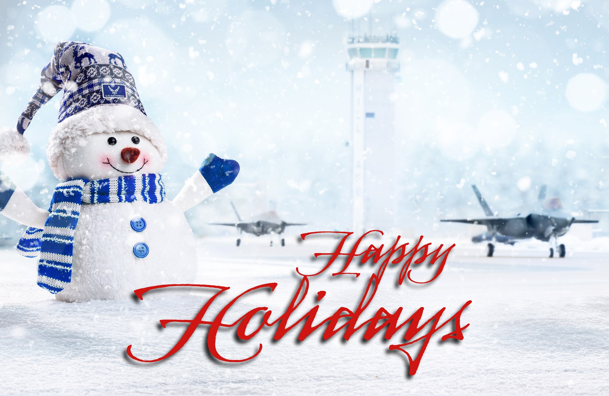 A illustration depicting a snowman with blue hat, scarf and mittens on a snow-covered runway at Hill Air Force Base with the air traffic control tower and two F-35A Lightning IIs taxiing in the background. The words Happy Holidays in red are centered next to the snowman.