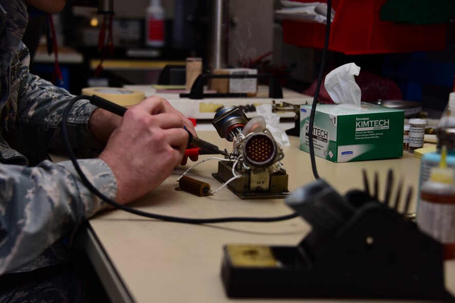 Airman works on equipment