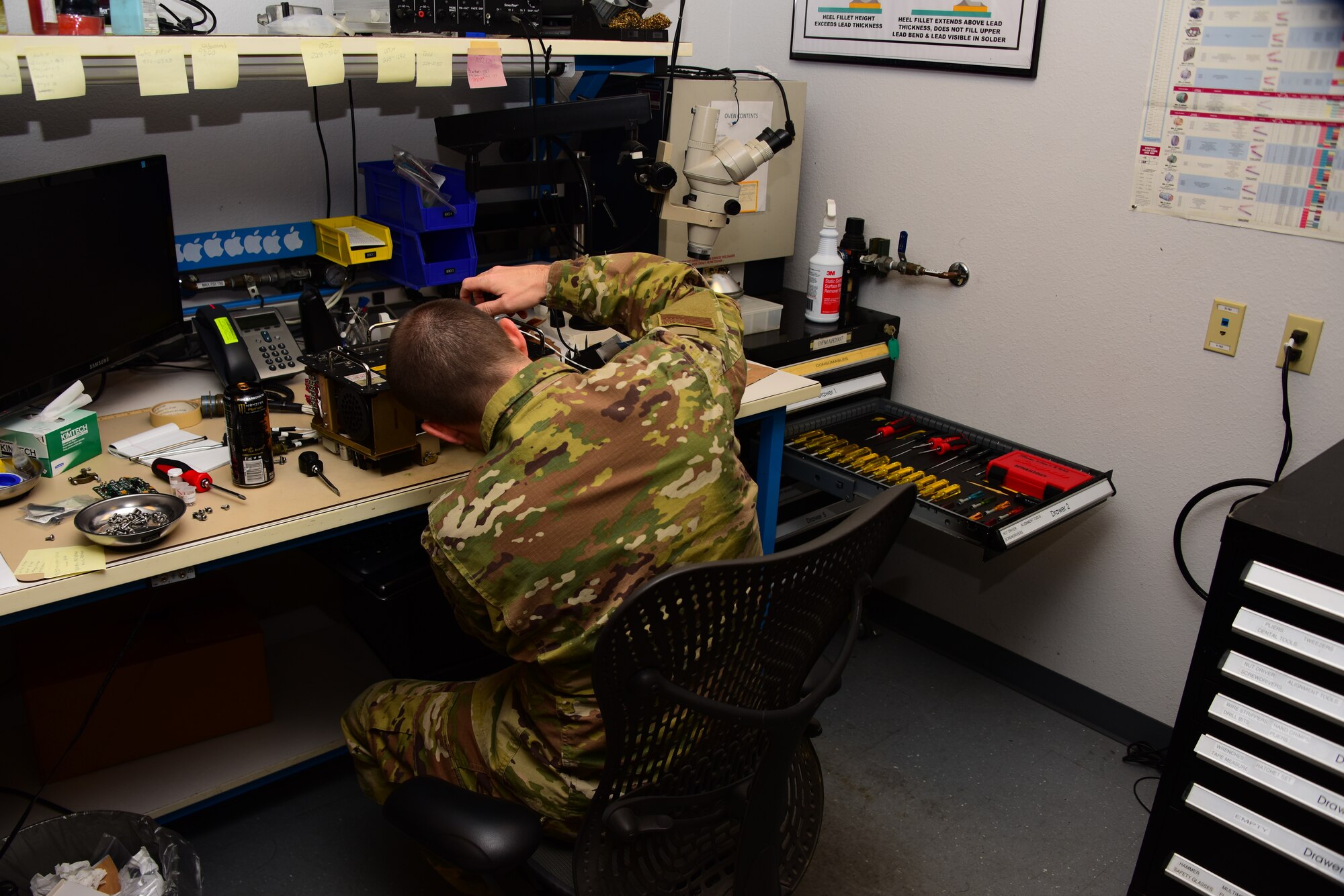 Airman works on equipment