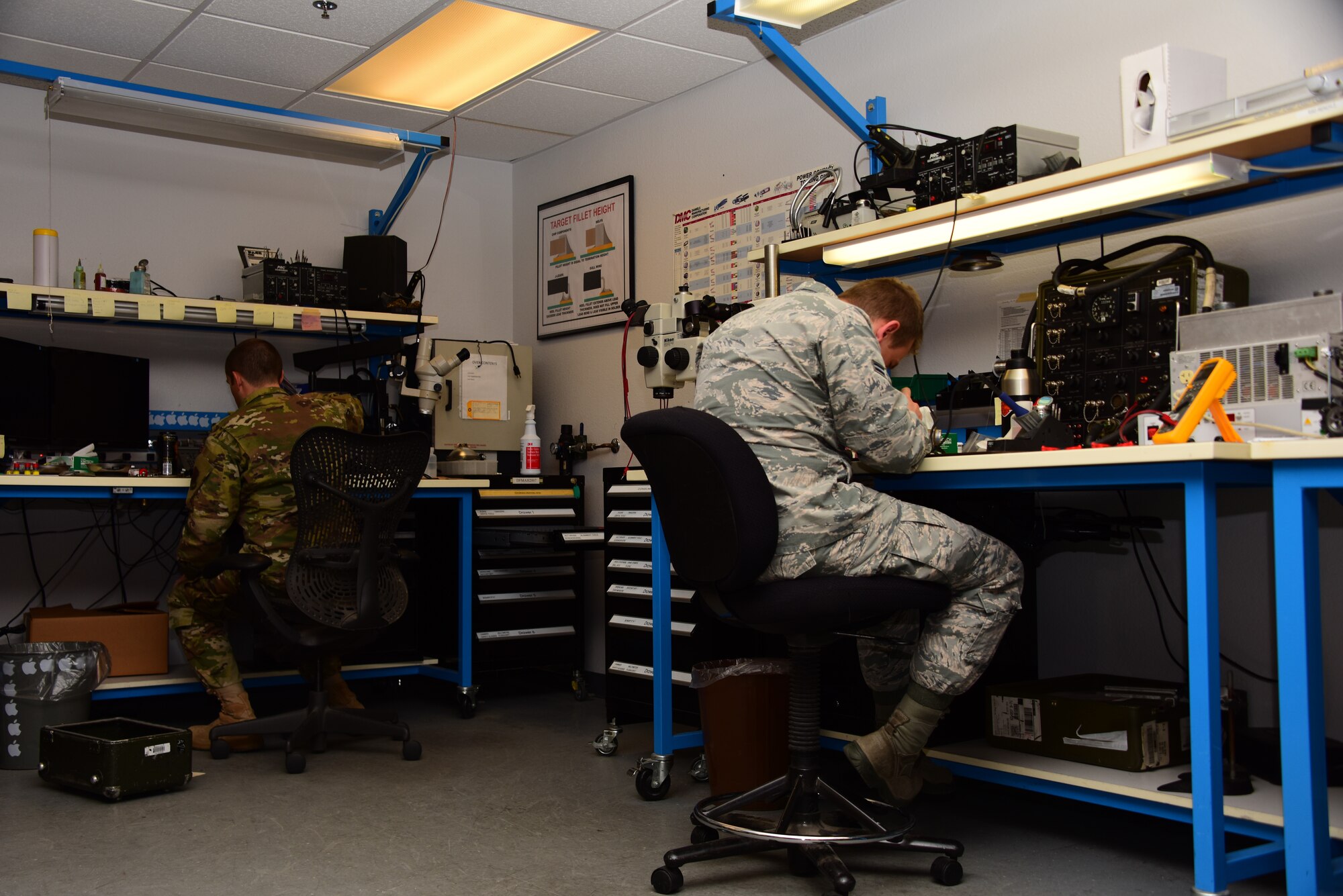 Airmen work in shop