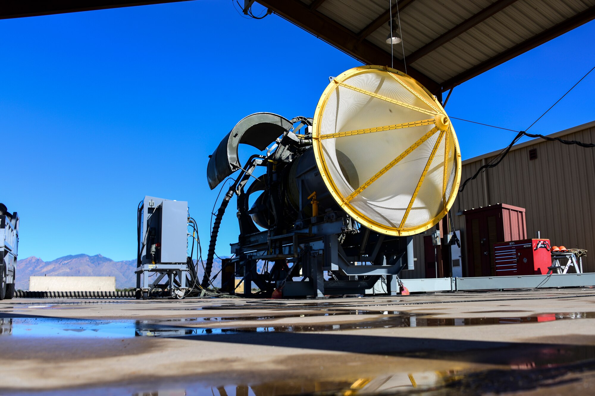 An engine sits under hangar