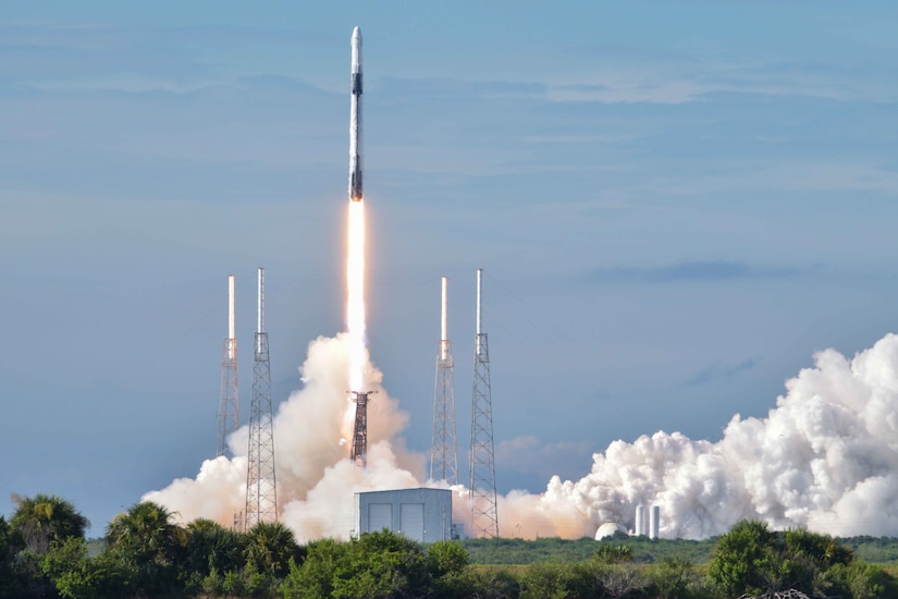 A column of flame and smoke billows from beneath a rocket as it launches into space.