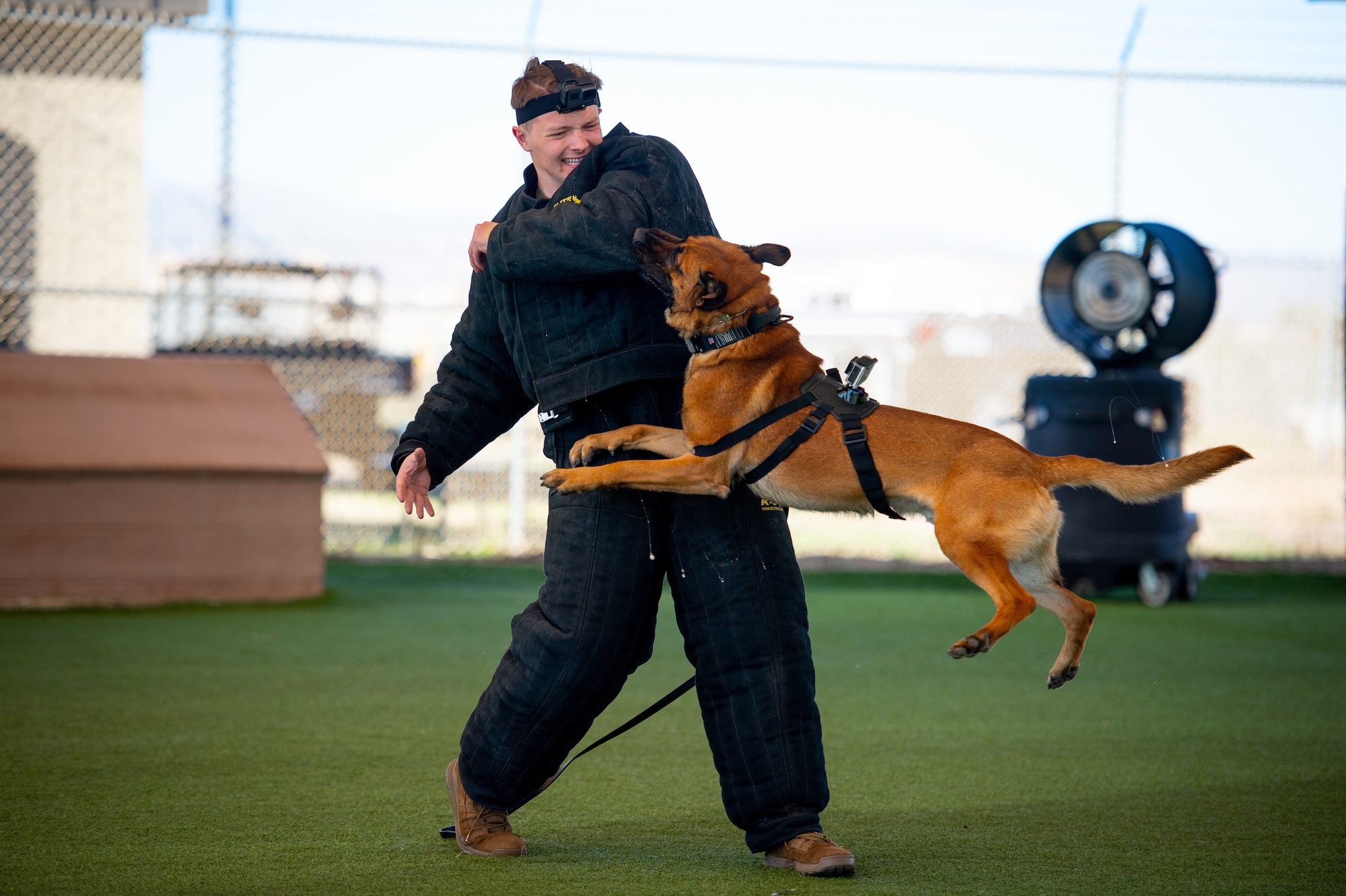 Senior Airman demonstrates K-9 bite training with MWD