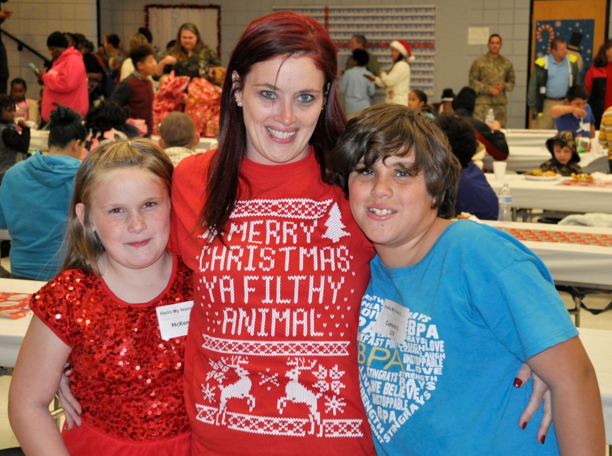 Tiffany Eldridge and her two children were all smiles Dec. 19 at the annual “Spread the Joy” event sponsored by the Air Force Civil Engineer Center Emergency Management team from Tyndall Air Force Base, Fla.