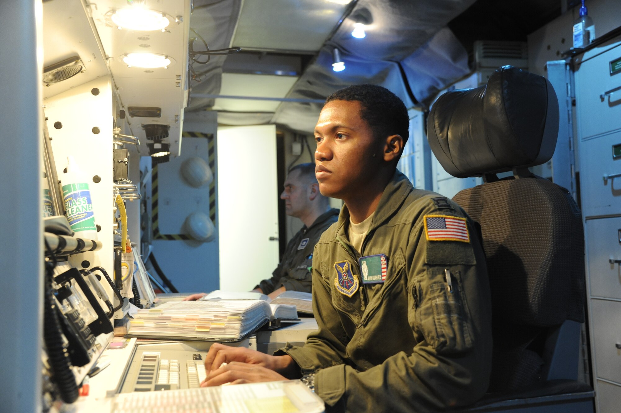 Capt. Javon Quarles, 321st Missile Squadron mission combat crew commander, responds to a message during his second alert as an individual mobilization augmentee. Quarles served 4 years on active duty with the 321st MS and transitioned into the Air Force Reserve earlier this year.  (U. S. Air Force photo by Glenn S. Robertson)