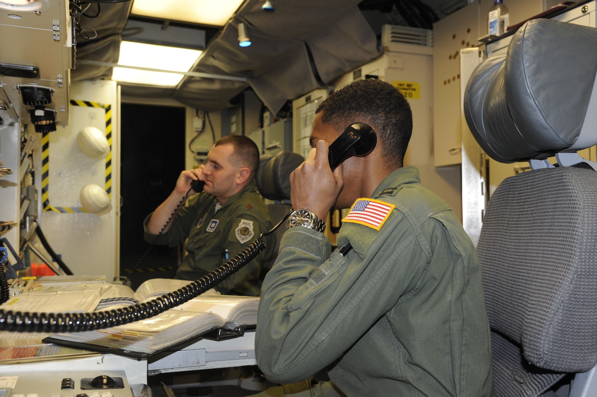 Capt. Javon Quarles, 321st Missile Squadron mission combat crew commander, takes a phone call from the flight security controller during his second alert as an IMA. Quarles served 4 years on active duty with the 321st MS and transitioned into the Air Force Reserve earlier this year. (U. S. Air Force photo by Glenn S. Robertson)