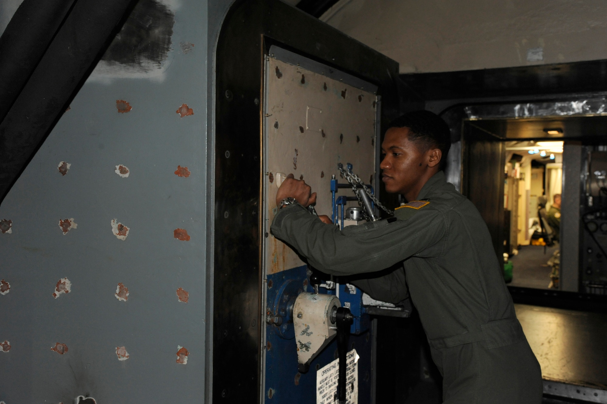 Capt. Javon Quarles, 321st Missile Squadron mission combat crew commander, pulls the blast door to the capsule closed during his second alert as an individual mobilization augmentee. Quarles served 4 years on active duty with the 321st MS and transitioned into the Air Force Reserve earlier this year.  (U. S. Air Force photo by Glenn S. Robertson)