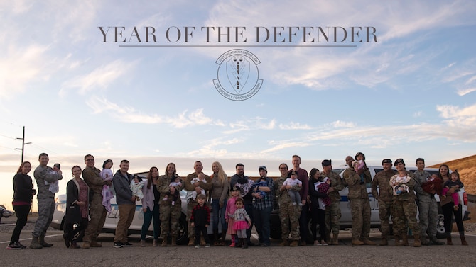 366th Security Forces Squadron members pose with their families Nov. 20, 2019 at Mountain Home Air Force Base, Idaho. The 366th SFS has shown support for new families. (U.S. Air Force photo illustration by Airman Natalie Rubenak)