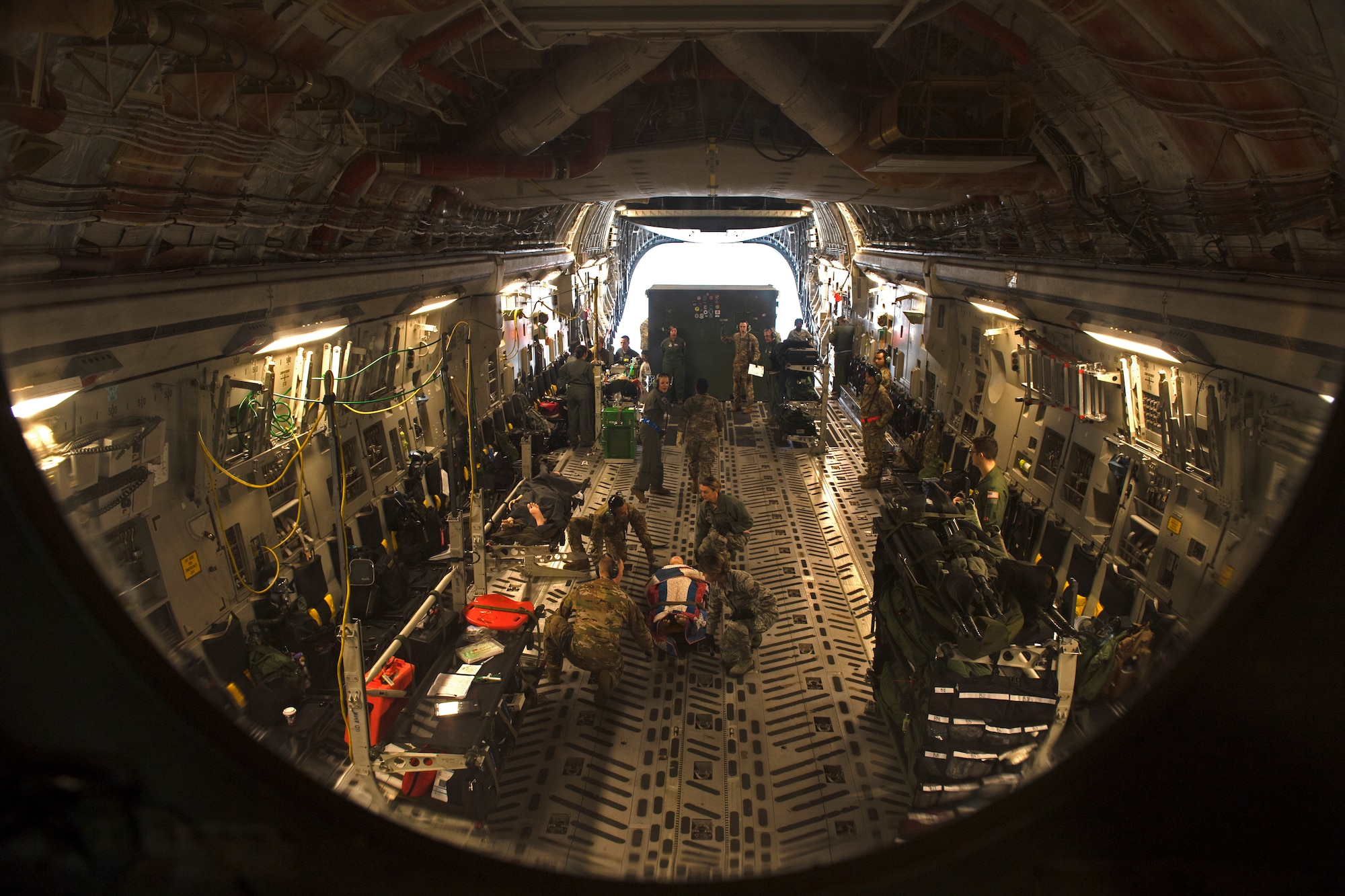 photos of Airmen practicing aeromedical evacuation on a C-17 Globemaster III from Travis AFB, California.