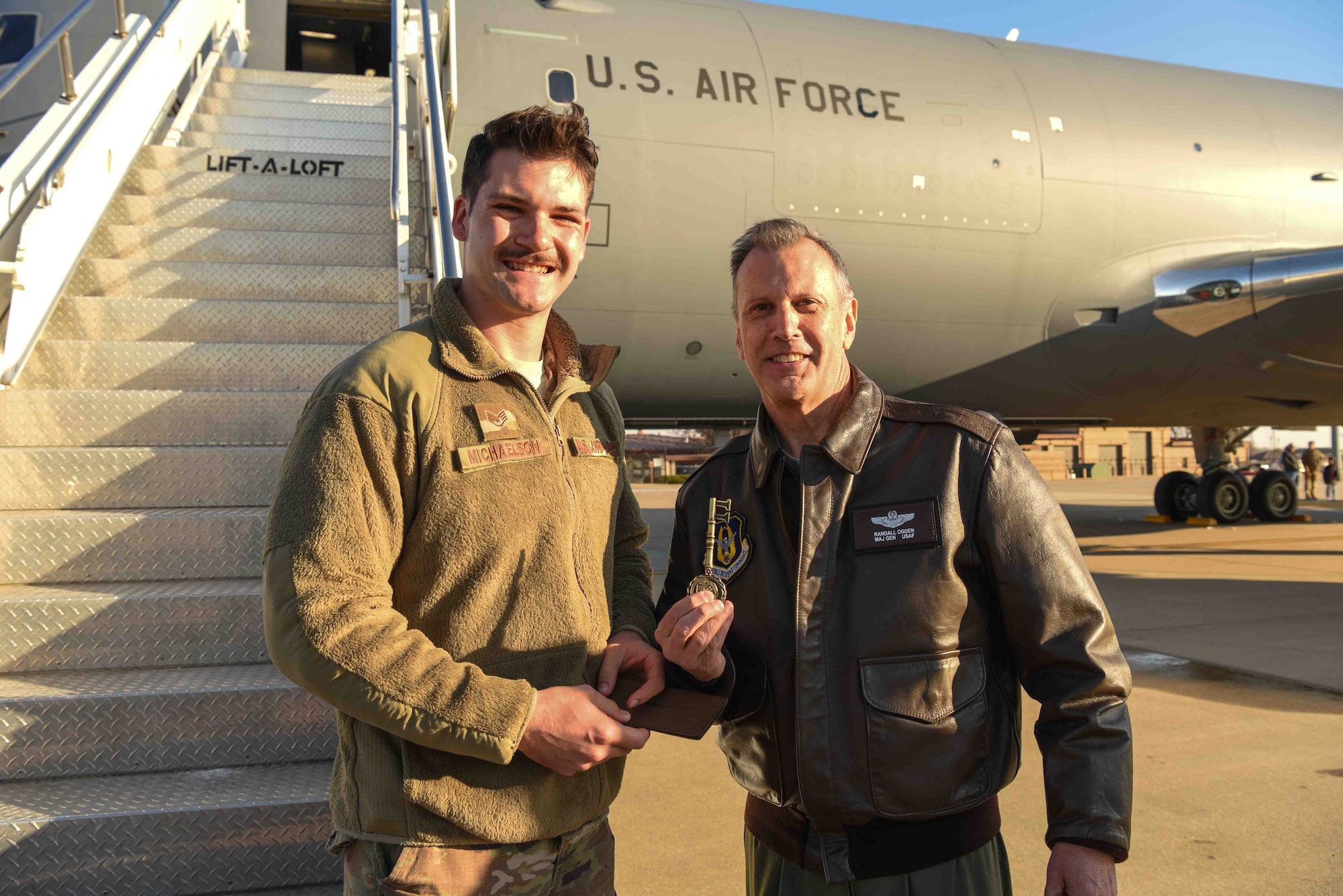 Staff Sgt. Ian Michaelson, 931st Aircraft Maintenance Squadron crew chief, hands Maj. Gen. Randall A. Ogden, 4th Air Force commander, the key of the aircraft, Dec. 20, 2019, at McConnell Air Force Base, Kan. The installation will be receiving 36 total KC-46A Pegasus aircraft. (U.S. Air Force photo by Airman 1st Class Alexi Bosarge)