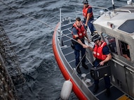 Coast Guardsmen secure communications equipment to a line to bring it aboard USS Thomas Hudner (DDG 116) in the Gulf of Mexico Dec. 16, 2019. The Navy used that equipment during the first demonstration of the Advanced Battle Management System, operators across the Air Force, Army, Navy and industry tested multiple real-time data sharing tools and technology in a homeland defense-based scenario enacted by U.S. Northern Command and enabled by Air Force senior leaders at Eglin Air Force Base, Fla., Dec. 16-18. (U.S. Air Force photo by 2nd Lt. Karissa Rodriguez)