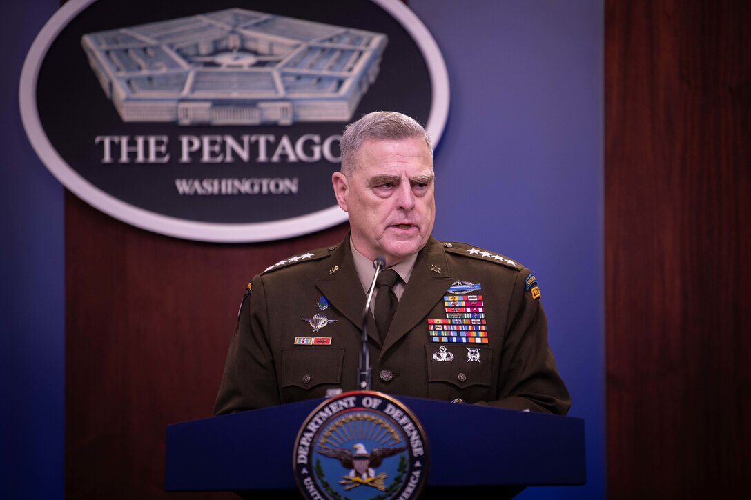 A military officer speaks to reporters from behind a podium.