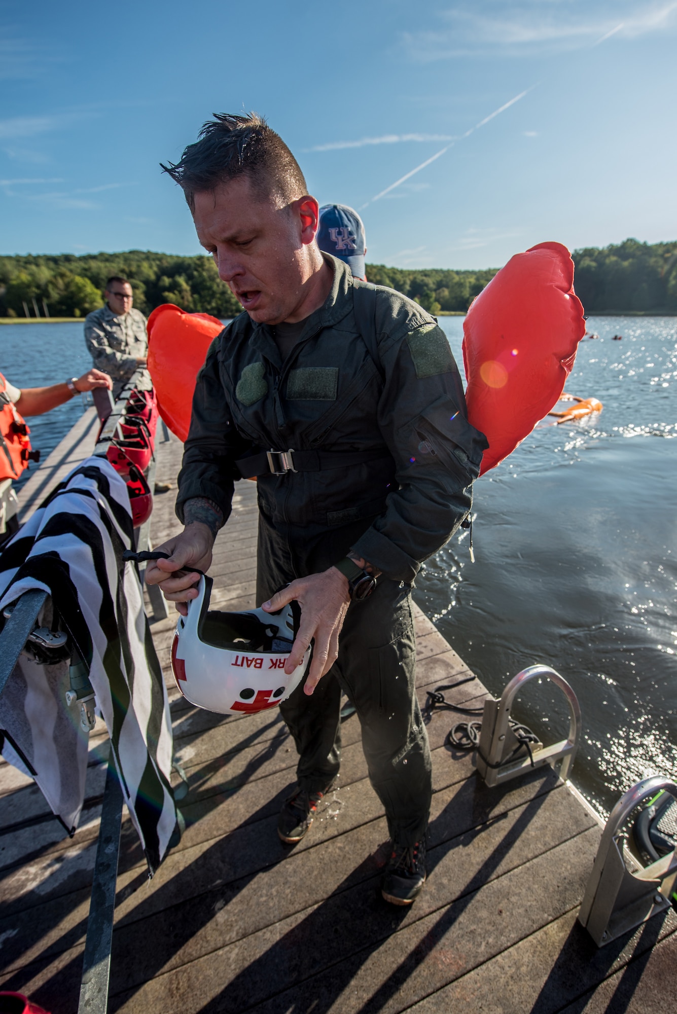 Master Sgt. Darren Wiles, a loadmaster for the Kentucky Air National Guard’s 123rd Contingency Response Group, removes his personal protective equipment after being pulled across the water at Camp Crooked Creek in Shepherdsville, Ky., Sept. 14, 2019, by a personal watercraft as part of routine survival training. The exercise is designed to simulate what could happen to aircrew members who’ve parachuted into water when the wind catches their open chutes and drags them across the surface, posing the risk of drowning. (U.S. Air National Guard photo by Staff Sgt. Joshua Horton)