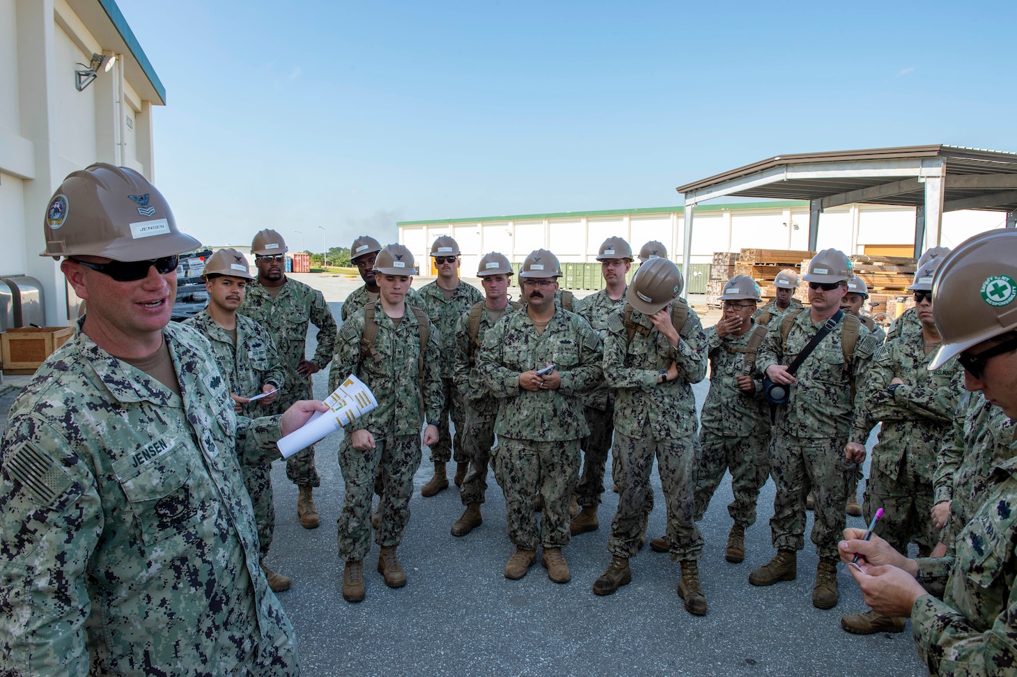 OKINAWA, Japan (Dec. 16, 2019) Construction Mechanic 1st Class Edwin Jensen, deployed with Naval Mobile Construction Battalion (NMCB) 5, issues the watch bill prior to receiving simulated orders during a 48-hour Mount-Out Exercise (MOX) on board Camp Shields, Okinawa. This exercise tests the battalion’s ability to deploy 89 personnel and 35-45 pieces of civil engineer support equipment within 48-hours to support major combat operations or humanitarian aid/disaster relief. NMCB-5 is deployed across the Indo-Pacific region conducting high-quality construction to support U.S. and partner nations to strengthen partnerships, deter aggression, and enable expeditionary logistics and naval power projection.