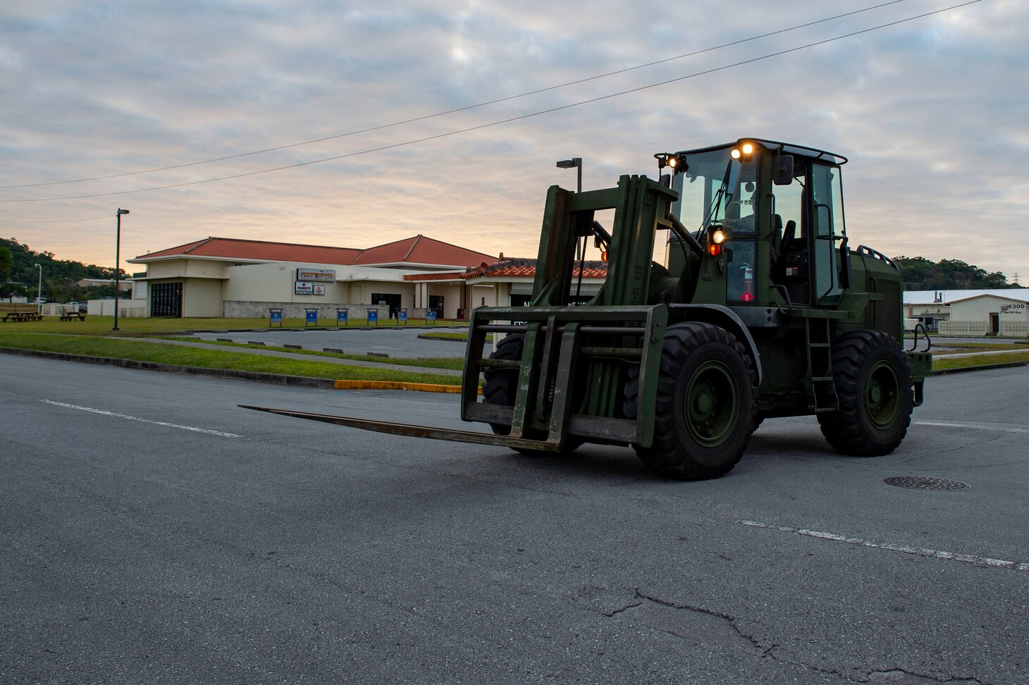 OKINAWA, Japan (Dec. 17, 2019) Equipment Operator 2nd Class Reynaldo Arcadio, deployed with Naval Mobile Construction Battalion (NMCB) 5, operates an all-terrain forklift after transporting equipment during a 48-hour Mount-Out Exercise on board Camp Shields, Okinawa. This exercise tests the battalion’s ability to deploy 89 personnel and 35-45 pieces of civil engineer support equipment within 48-hours to support major combat operations or humanitarian aid/disaster relief. NMCB-5 is deployed across the Indo-Pacific region conducting high-quality construction to support U.S. and partner nations to strengthen partnerships, deter aggression, and enable expeditionary logistics and naval power projection.