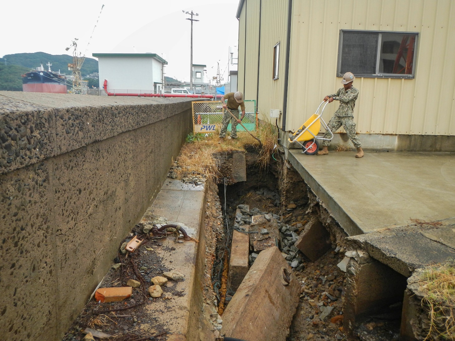 SASEBO, Japan (Oct. 28, 2019) Builder 3rd Class Lawrence Spears, from Houston, deployed with Naval Mobile Construction Battalion (NMCB) 5’s Detail Sasebo, places riprap to repair critical infrastructure damage to the seawall on Commander Fleet Activities Sasebo to further improve the base’s military readiness and capability.  NMCB-5 is deployed across the Indo-Pacific region conducting high-quality construction to support U.S. and partner nations to strengthen partnerships, deter aggression, and enable expeditionary logistics and naval power projection.
