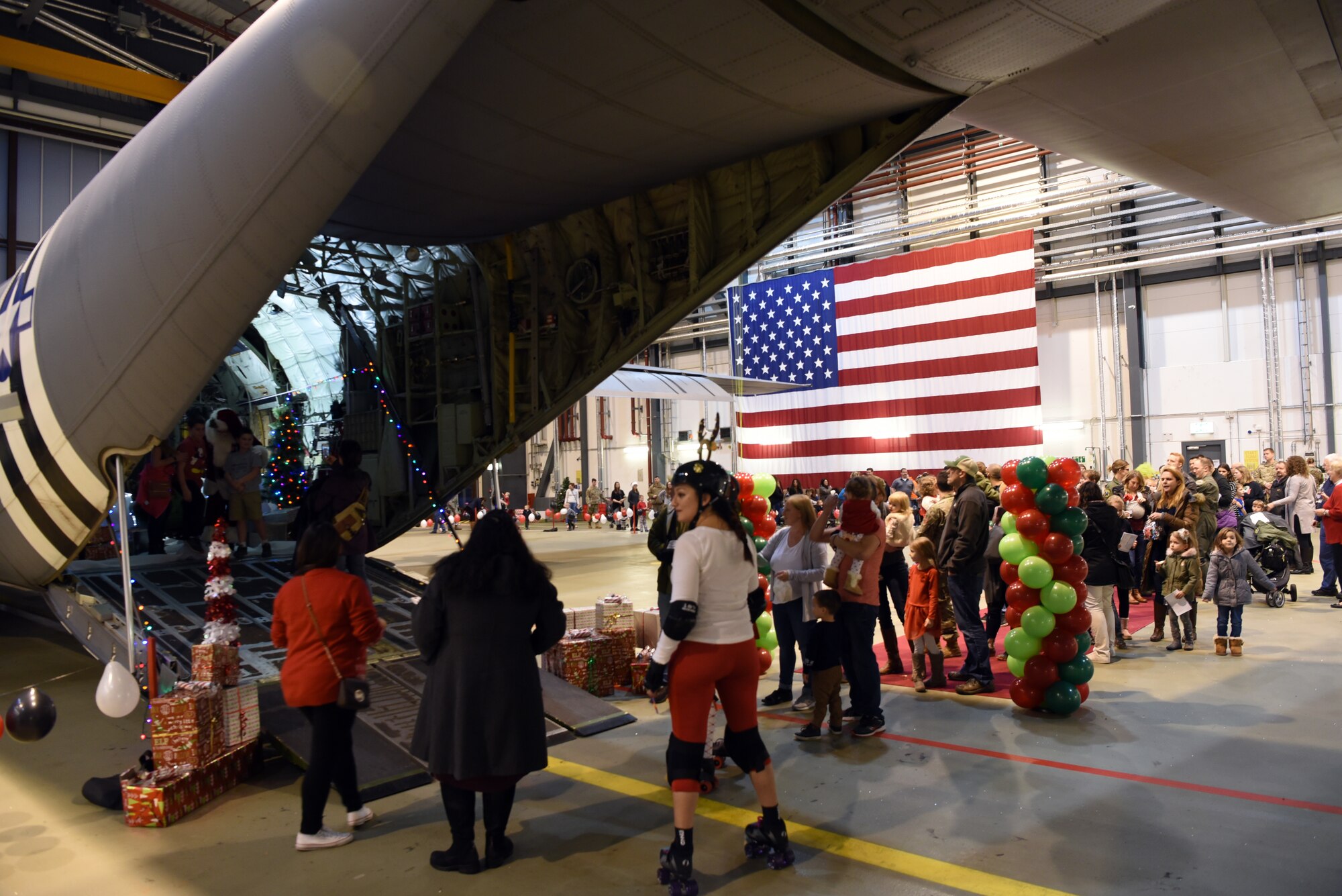 Families gather and wait in line to see Santa during the Rudolph the Red Nosed Herc event at Ramstein Air Base, Germany, Dec. 20, 2019.