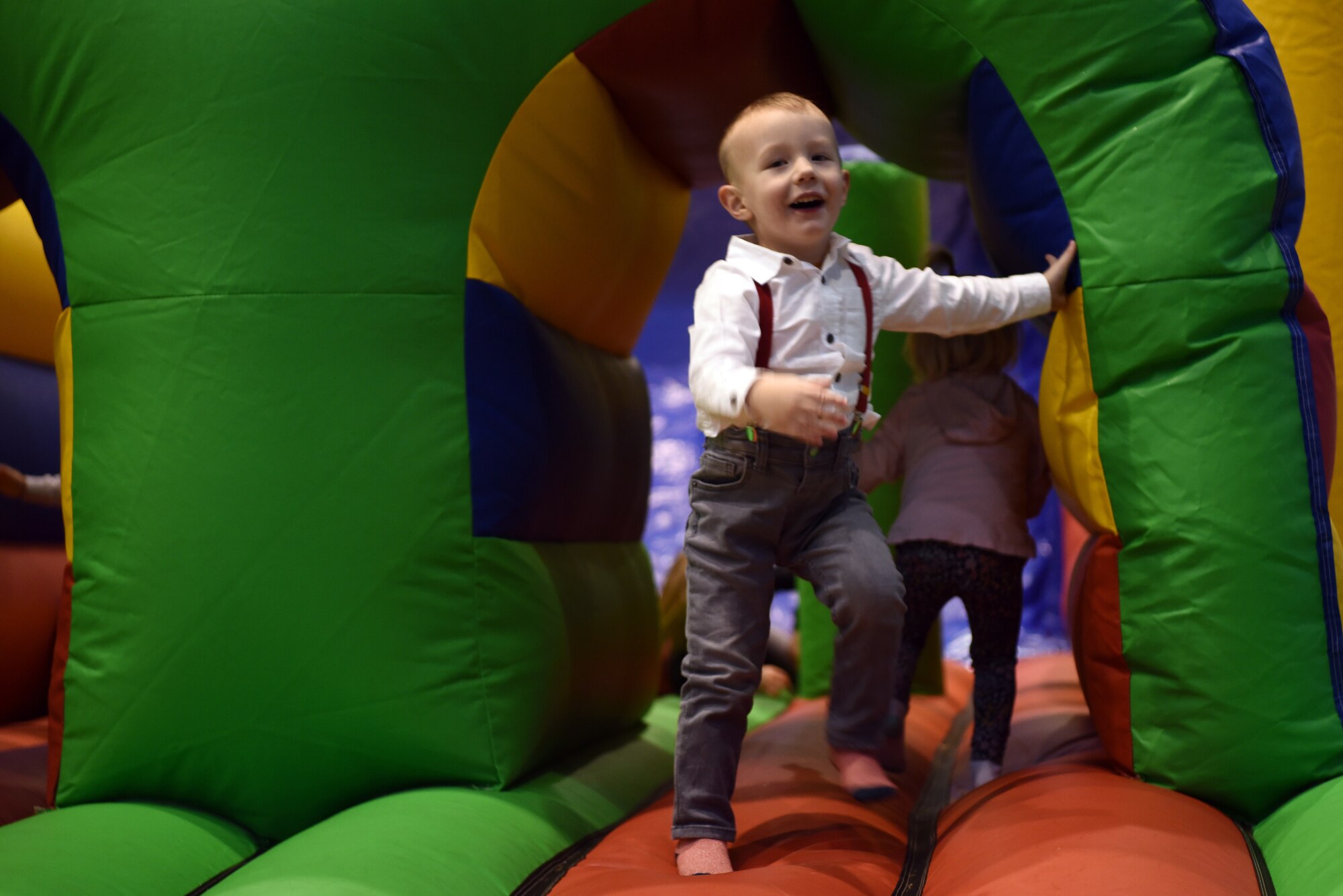 Bryson, son of Jameson Kaye, 86th Maintenance Group field service representative, plays on an inflatable slide and obstacle course during the Rudolph the Red Nosed Herc event at Ramstein Air Base, Germany, Dec. 20, 2019.