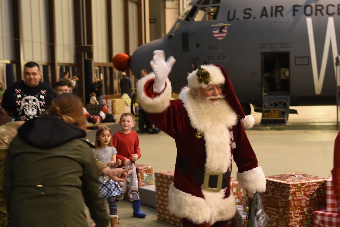 Santa greets and leads families around Rudolph the Red Nosed Herc during an event at Ramstein Air Base, Germany, Dec. 20, 2019.