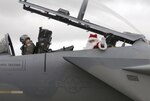 Santa Clause waves from the back seat of an F-15 Eagle