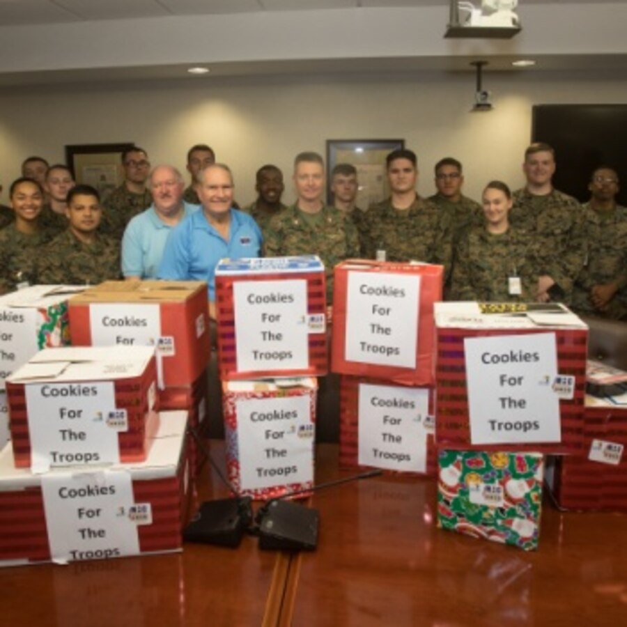 U.S. Marines assigned to Marine Corps Air Station (MCAS) Cherry Point, pose with members of the Carteret County’s Chamber of Commerce’s Military Affairs Committee during the annual cookie drop event at MCAS Cherry Point, North Carolina, Dec. 16, 2019. The cookie drop organized by Carteret County’s Chamber of Commerce’s Military Affairs Committee, donates baked goods to the Marines and Sailors on duty at the air station. (U.S. Marine Corps photo by Cpl. Micha Pierce)