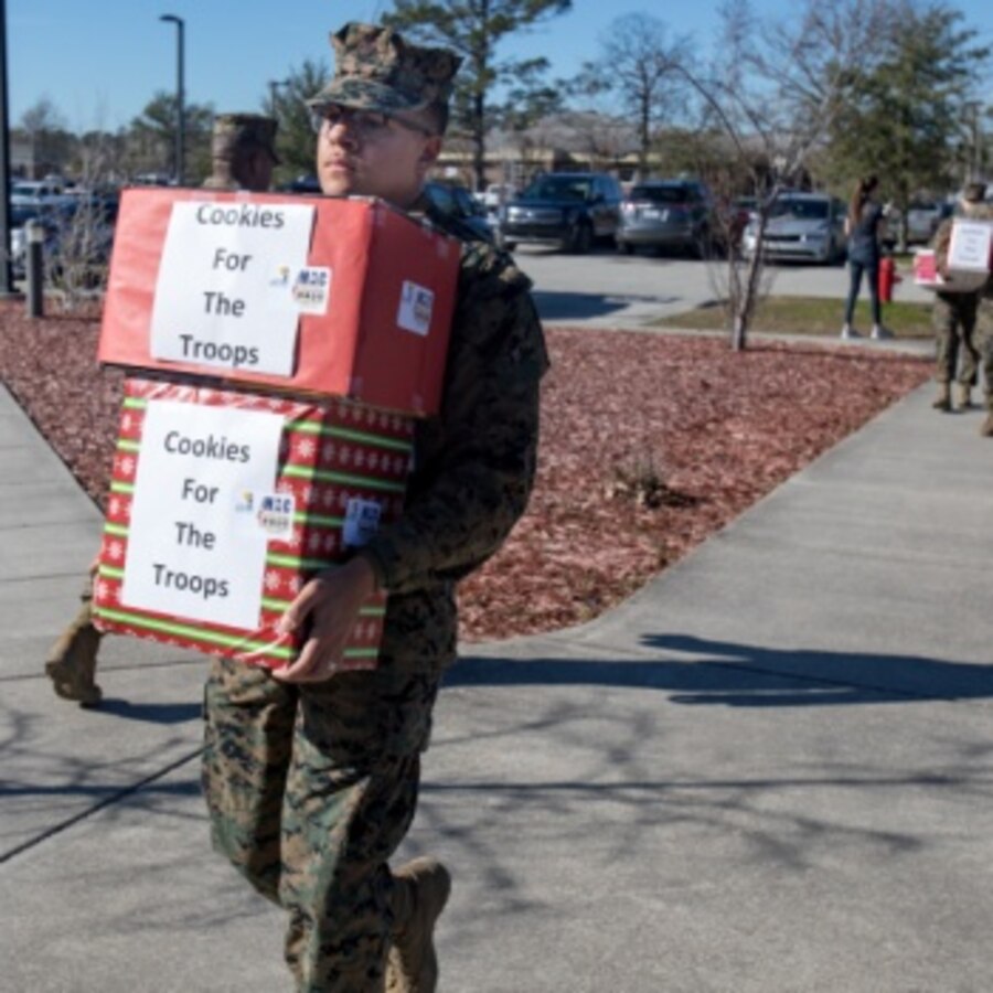 A U.S. Marine assigned to Marine Corps Air Station (MCAS) Cherry Point, helps carry in boxes of baked goods during the annual cookie drop event at MCAS Cherry Point, North Carolina, Dec. 16, 2019. The cookie drop organized by Carteret County’s Chamber of Commerce’s Military Affairs Committee, donates baked goods to the Marines and Sailors on duty at the air station. (U.S. Marine Corps photo by Cpl. Micha Pierce)