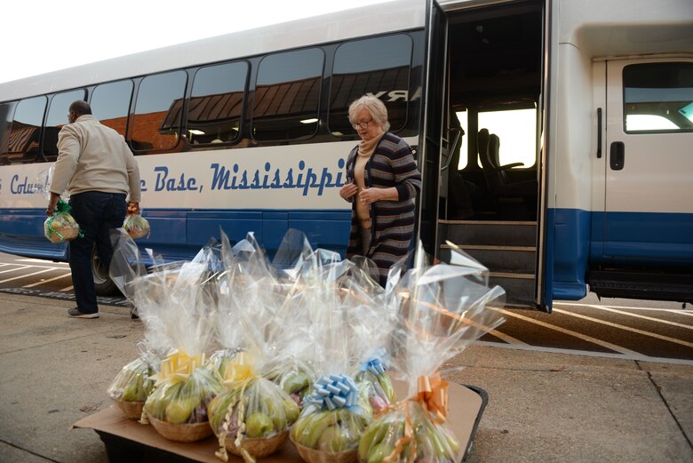 Fourteenth Flying Training Wing partners load fruit baskets onto a bus for the Happy Irby Christmas Fund Dec. 12, 2019, at Columbus Air Force Base, Miss. In 1996, the Happy Irby Fund became part of the Combined Federal Campaign with 100 percent of donations collected used to provide gifts to adults and children. (U.S. Air Force photo by Airman Davis Donaldson)