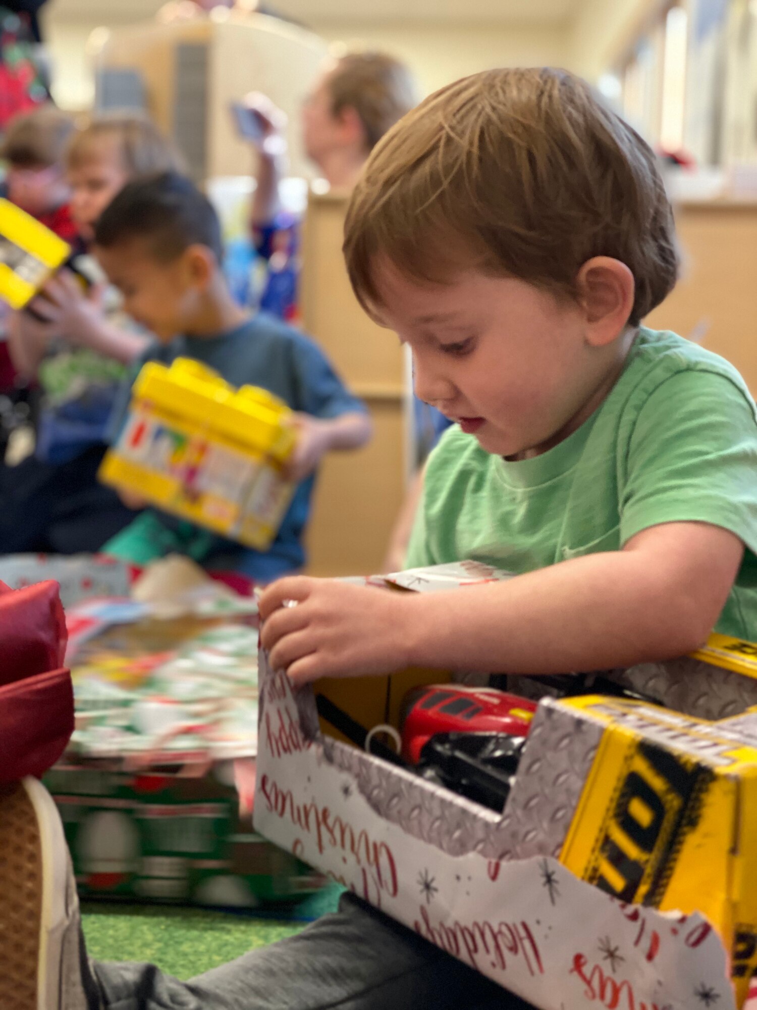 Children open their presents from Santa at the Youth & Family Services Center in Rapid City, S.D., Dec. 17, 2019. Each year, the 28th Operations Group puts together Angel Tree, collecting presents to gift to children enrolled in YFS programs. (U.S. Air Force photo by Senior Airman Michael Jones)