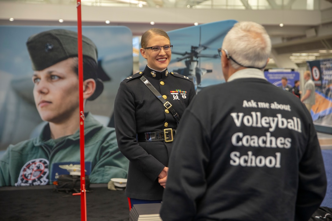 Captain Caroline Locksmith, the assistant logistics officer at Marine Barracks Washington, speaks with Bart Gensburg, a volleyball coach instructor at East Ohio Volleyball Club, during the American Volleyball Coaches Association (AVCA) National Convention in Pittsburgh, Pennsylvania, December 19, 2019. AVCA was founded in 1981 to help advance the sport of volleyball and provide a professional network of individuals and companies dedicated to enhancing and developing the sport. AVCA hosts its annual convention during the NCAA Division I Women’s National Championship and is the largest gathering of volleyball coaches in North America. The Marine Corps relationship with AVCA was initiated in 2015 with the goal of increasing awareness and positive perception of the Marine Corps within this influential community of coaches. (U.S. Marine Corps photo by Lance Cpl. Mitchell Collyer)