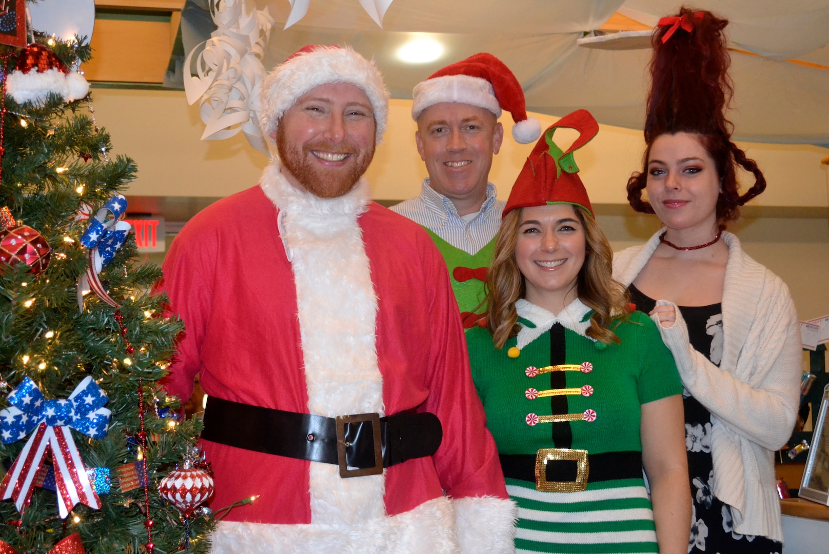 Festively costumed employees from DLA Troop Support’s Subsistence supply chain pose in front of their display as a part of the annual decorating contest Dec. 20, 2019, in Philadelphia.