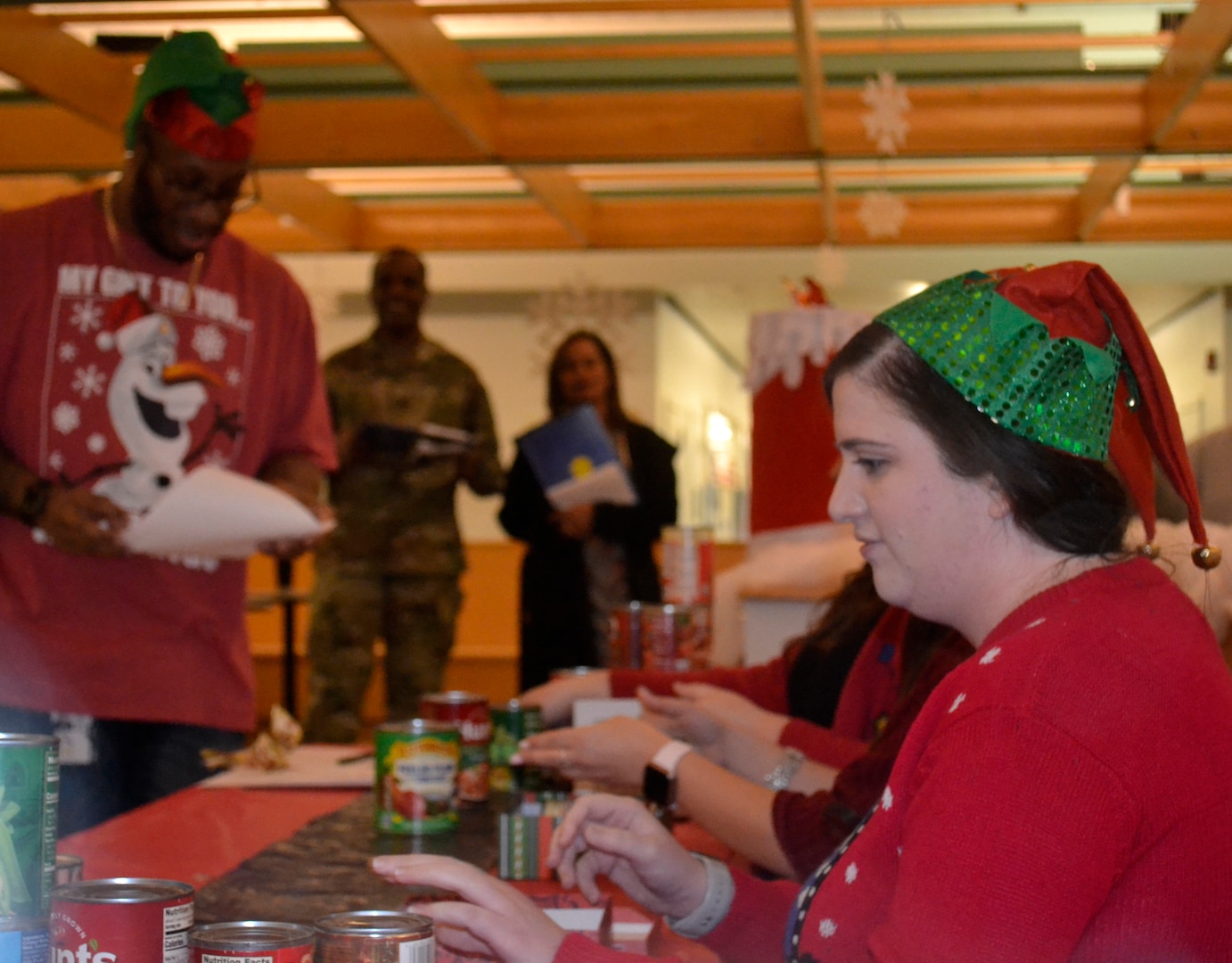 DLA Troop Support employees from the Clothing and Textiles supply chain perform a skit preparing items for Santa Claus to deliver to those in need during the annual Troop Support holiday decorating contest Dec. 20, 2019, in Philadelphia.