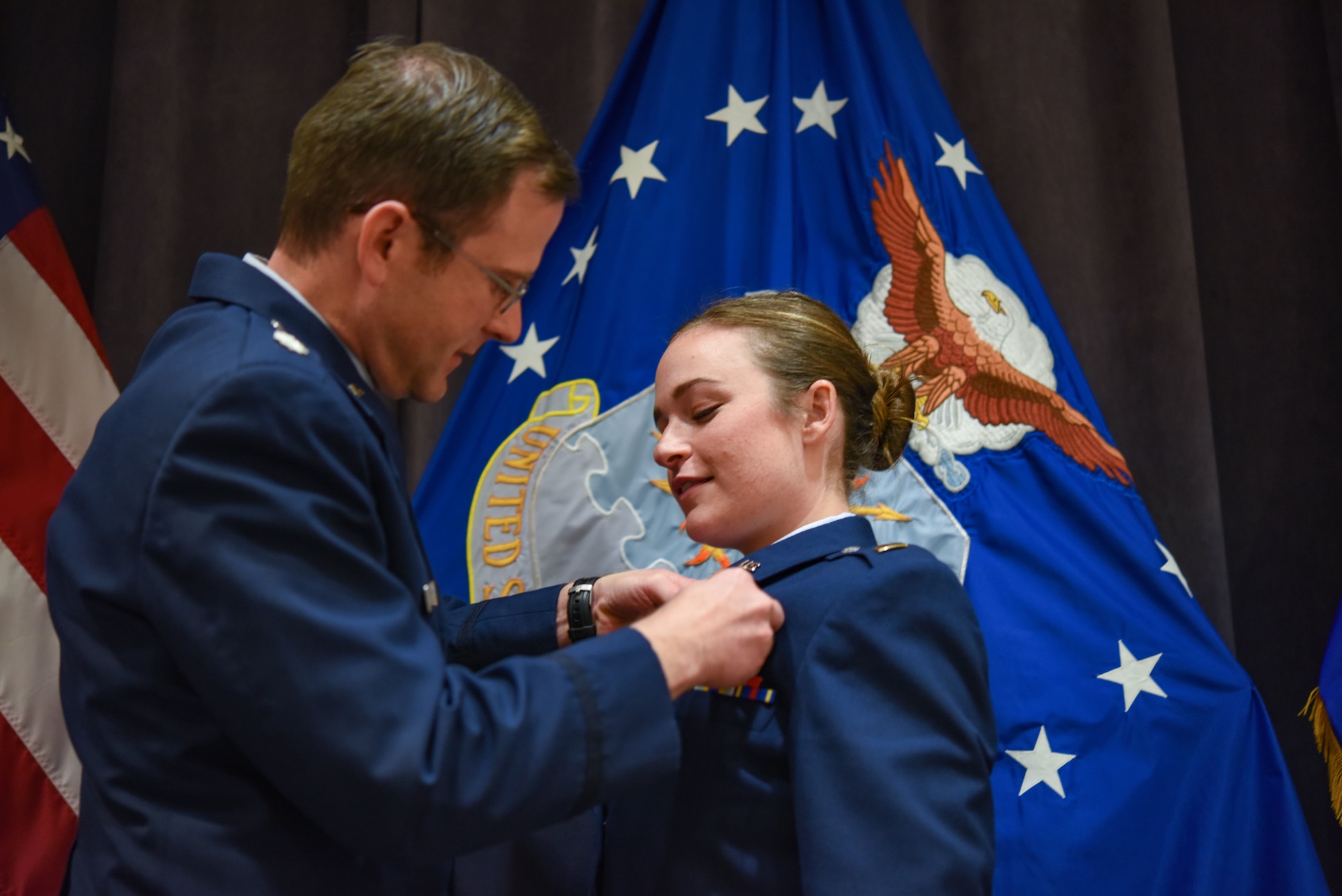 Second Lt. Kristen Savage receives her pilot’s wings during a dual commissioning and “winging” ceremony Dec. 19, 2019, at Maxwell Air Force Base, Alabama. Savage was a student pilot who graduated PTN version 2, an Air Education and Training Command program to explore what is possible in training with the use of innovative technology and how it can be applied to not only pilot training but also to training across AETC.  She earned her wings, but couldn’t wear them until she commissioned. (U.S. Air Force photo by Staff Sgt. Quay Drawdy)