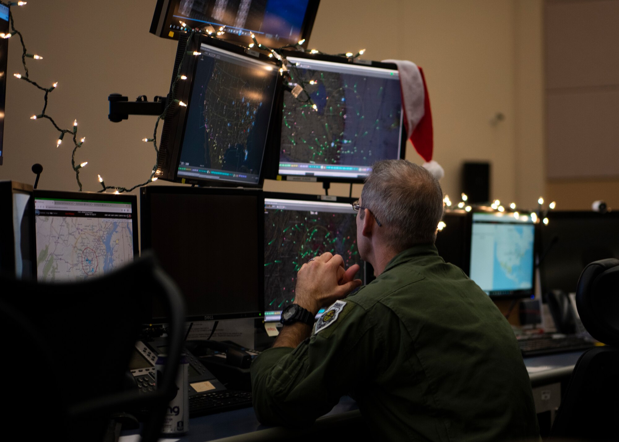 Lt. Col. Justin Podnar, 601st Air Operations Center senior air defense officer, tracks flight patterns of military aircraft to ensure Santa has a safe route for his deliveries, Tyndall Air Force Base, Florida, Dec. 23, 2019. North American Aerospace Defense Command uses their satellite technology to provide real time updates on Santa’s location across the world. (U.S. Air Force photo by Senior Airman Cheyenne Larkin)