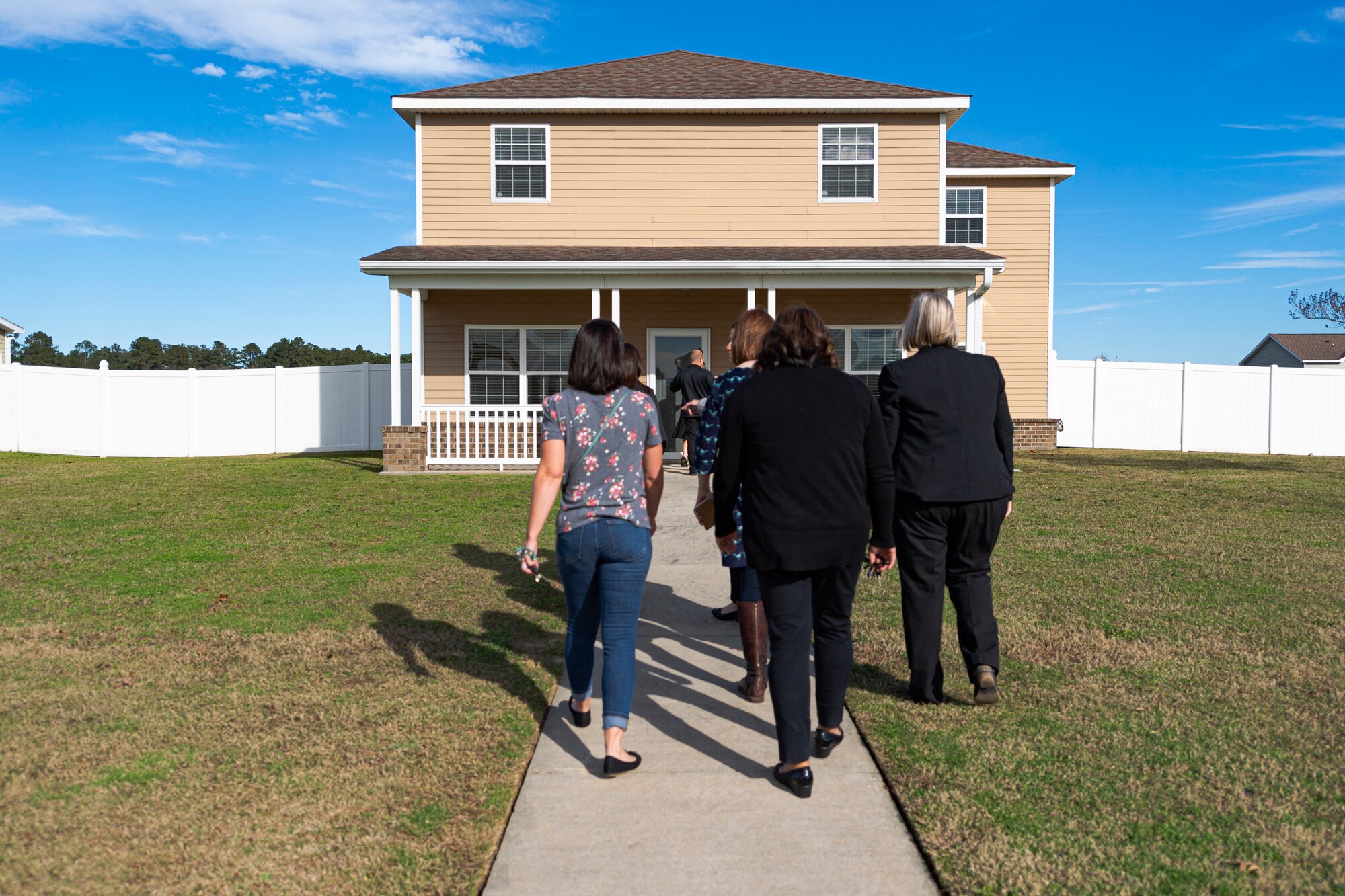 A photo of the housing manager giving a tour of base housing