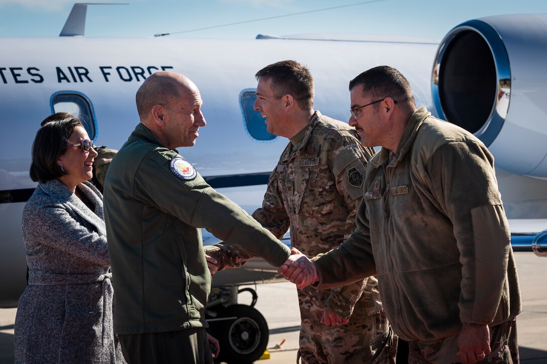 A photo of Airmen greeting the commander of Air Combat Command and his wife