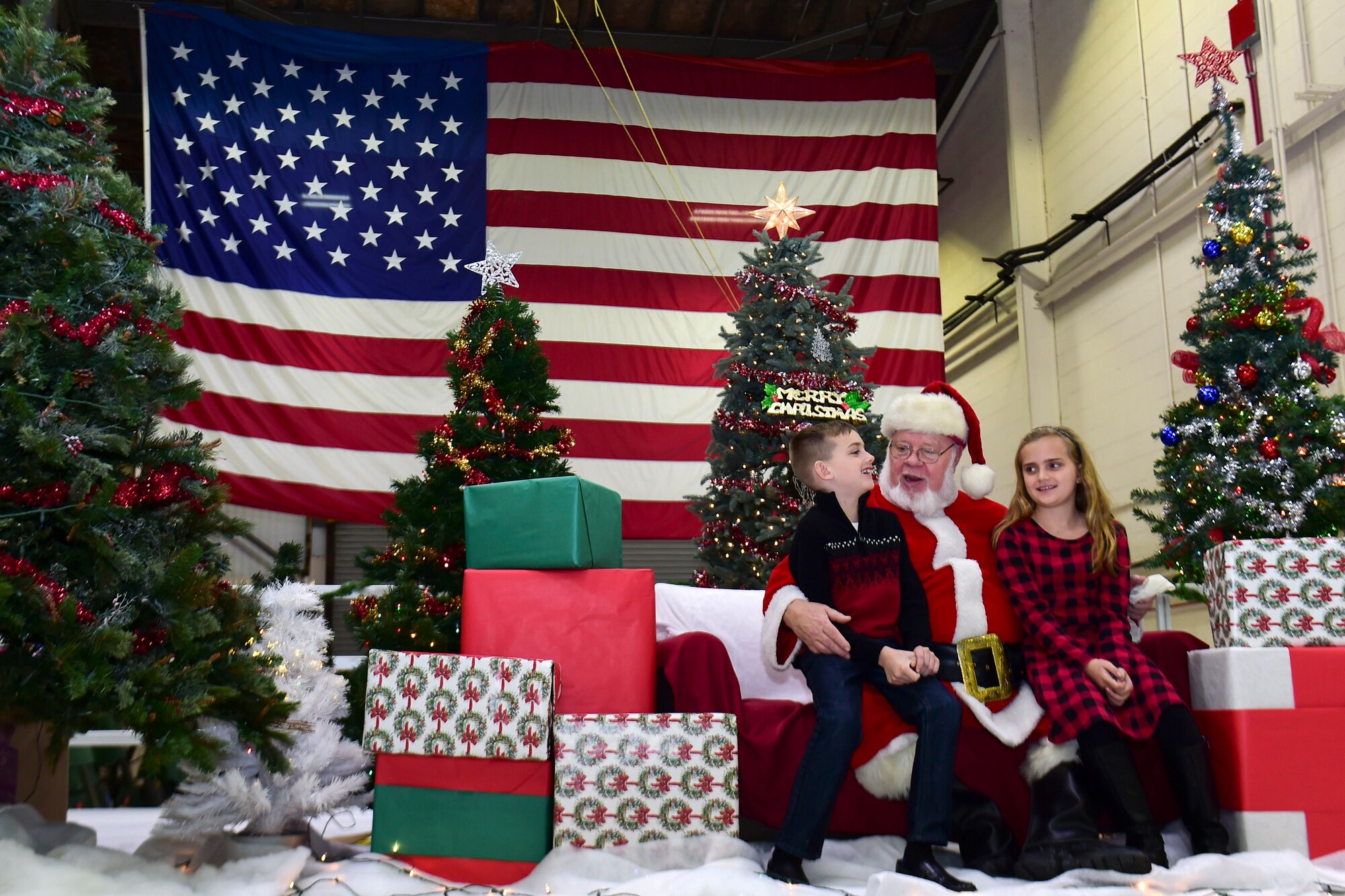 Lyndin and Lyla Davin sit with Santa during the Kids’ Christmas Party at Grissom Air Reserve Base, Indiana, Dec. 7, 2019.  The 434th Force Support Squadron Airman and Family Readiness Center transformed Dock 1 into a Christmas wonderland complete with cookie decorating, toys and hot cocoa.  (U.S. Air Force Photo by Staff Sgt. Chris Massey)