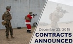 Marines conduct range operations with a man dressed in Santa suit.