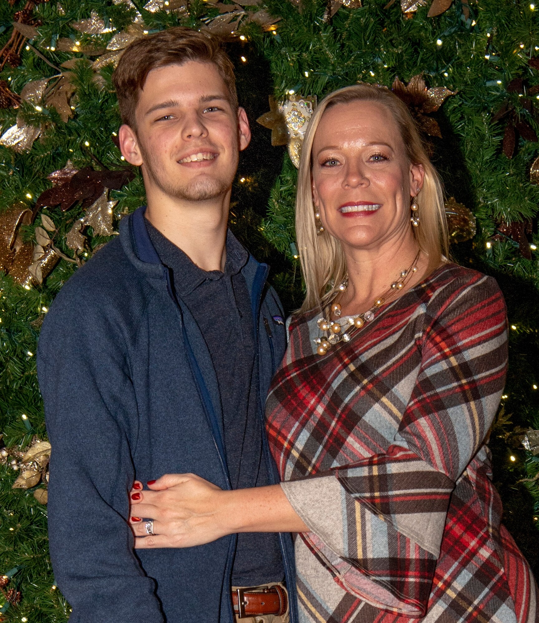 Photo of Caleb Linnane posing with his mother, U.S. Air Force Tech. Sgt. Lindsey R. Barnes