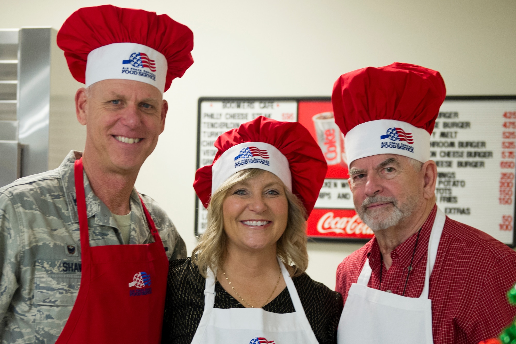 Col. Larry Shaw, 434th Air Refueling Wing Commander, poses for a photo with his wife Kris and Grissom Community Council member Hal Job, in the dining facility at Grissom Air Reserve Base, Indiana, Dec. 7, 2019. Wing leadership and GCC members helped served holiday staples prepared by the 434th Force Support Squadron during the December Unit Training Assembly. (U.S. Air Force photo/ Staff Sgt. Courtney Dotson-Essett)