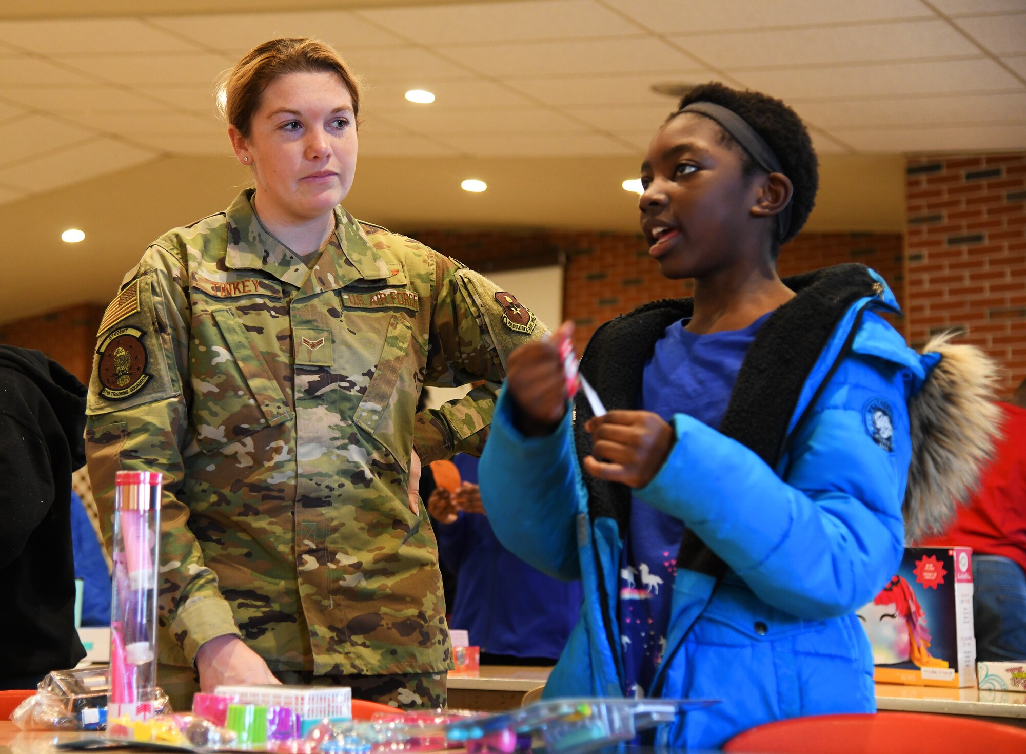 U.S. Air Force Airman First Class Grace Tinkey, 97th Training Squadron student, talks with Synthia Freeman at the Tipton Children’s Home, Tipton. Okla.